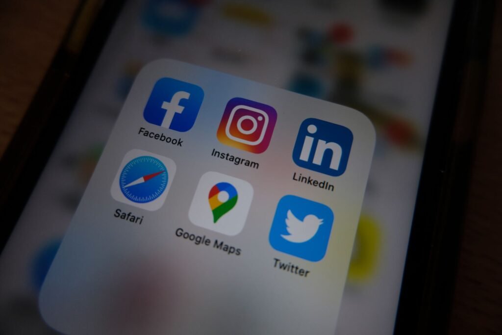 Smartphone screen full of social media app icons managed by an agency
