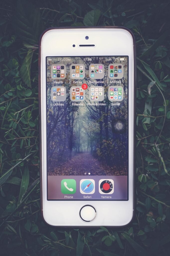 iPhone lying on grass, ready for an iOS 26 cache cleanup