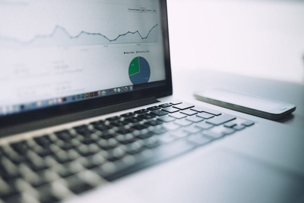 Laptop showing a free web analytics dashboard with traffic charts