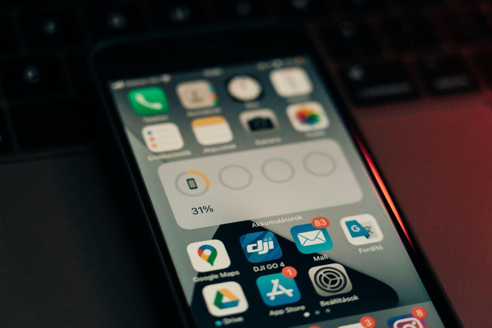 iPhone resting on a laptop keyboard during an ASO metadata audit
