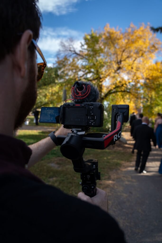 Videographer filming a wedding couple with a smartphone