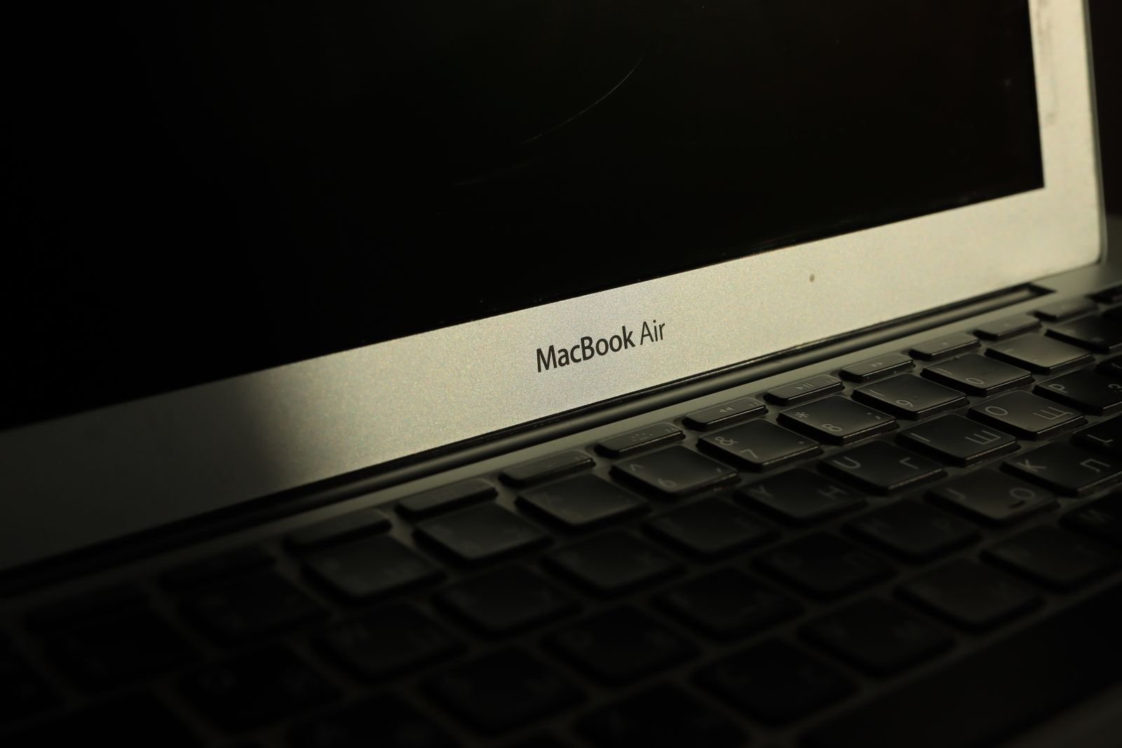 Sunlit MacBook Air on a desk during a video editing session