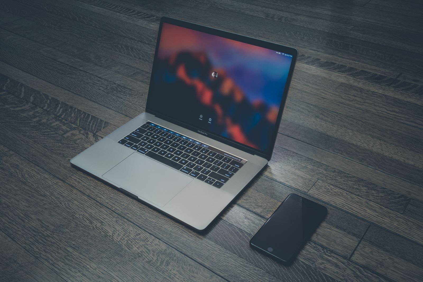 MacBook on a desk set up as a video editing workstation