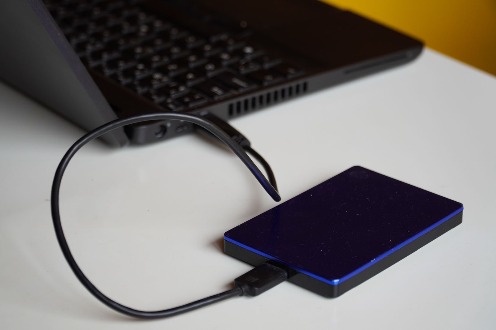 External drive connected to a laptop for offloading iPhone screen recordings