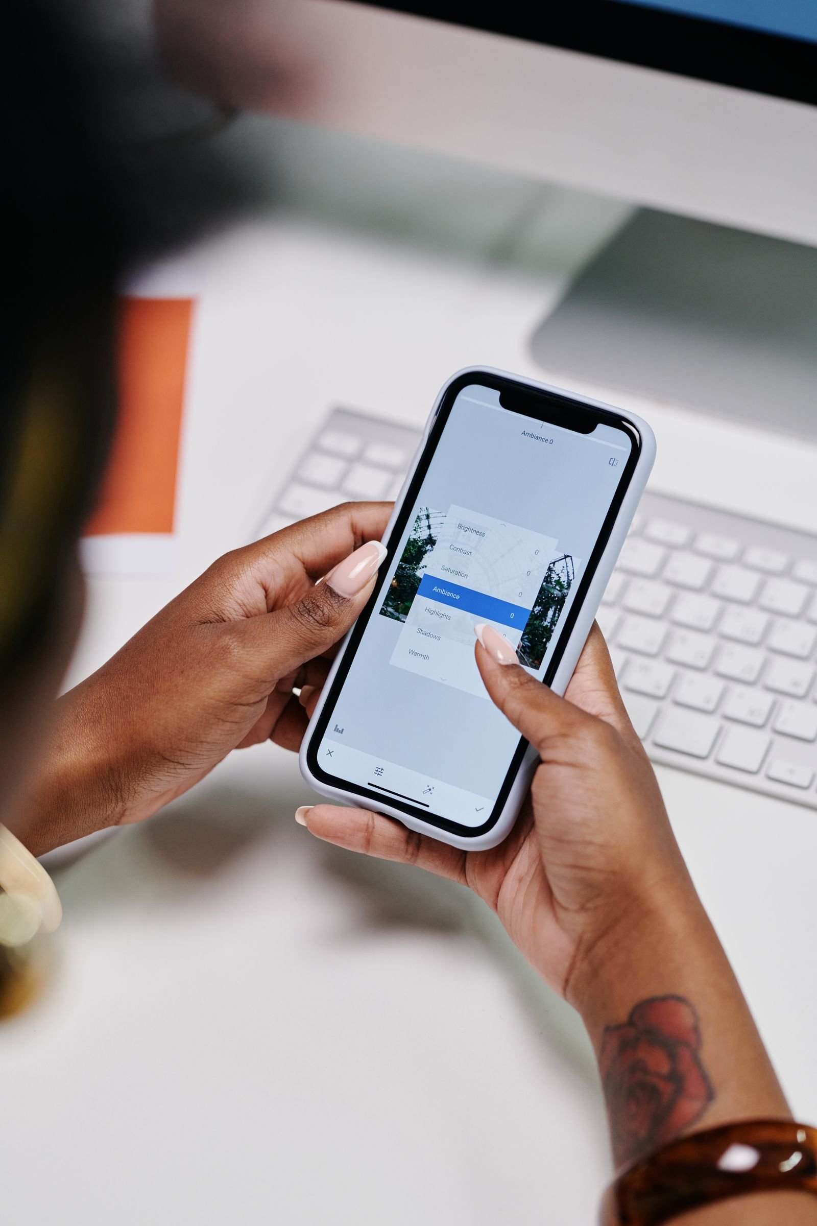 Person at a desk using an iPhone to manage Safari website data