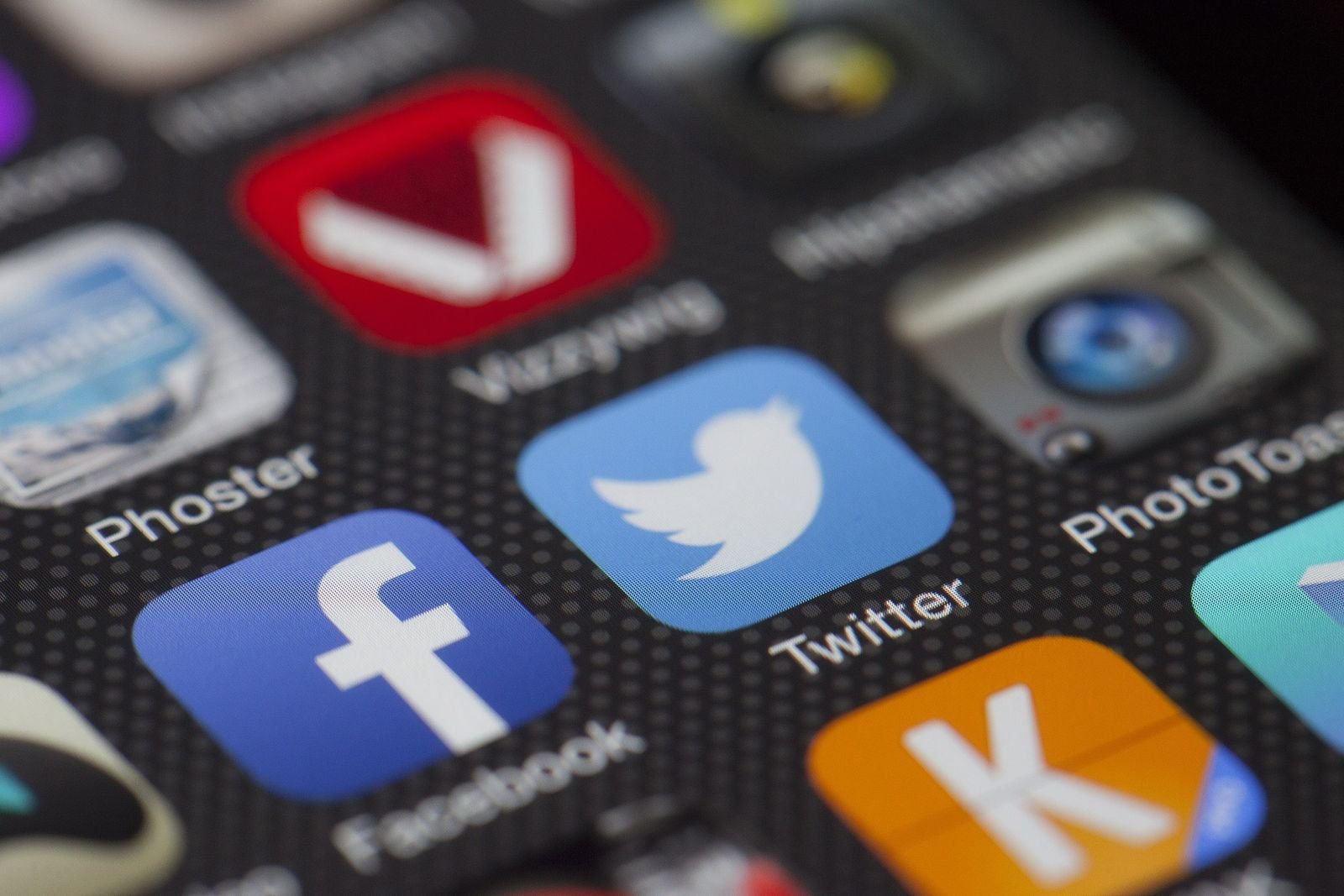 Close-up of social media app icons on a phone screen